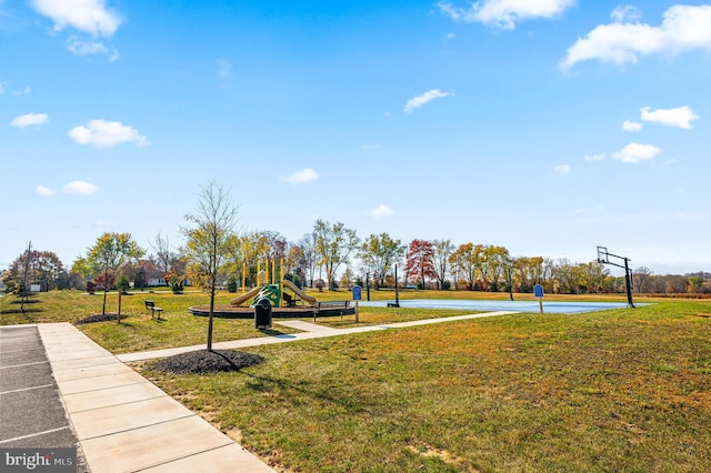 view of home's community with a playground and a yard