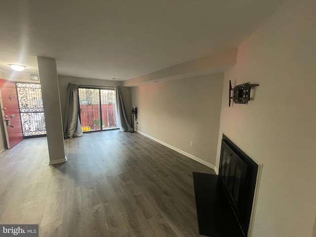 unfurnished living room featuring dark hardwood / wood-style flooring