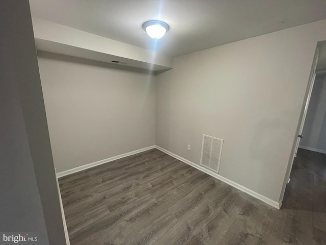 empty room featuring dark wood-type flooring