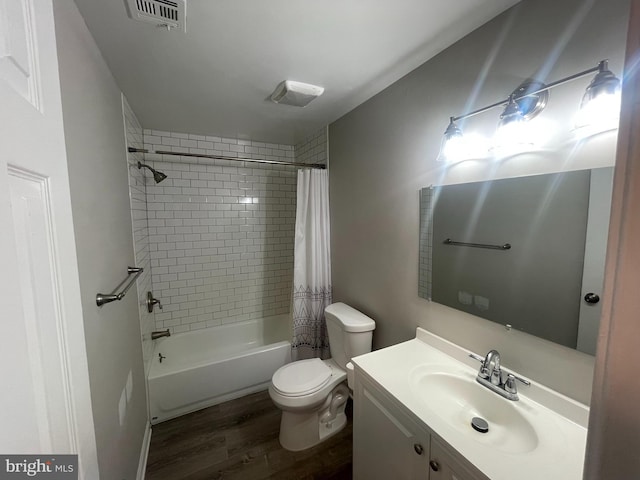 full bathroom featuring vanity, toilet, wood-type flooring, and shower / tub combo with curtain