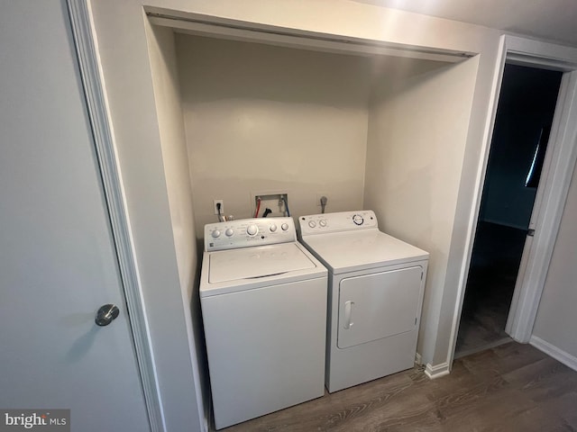 laundry room featuring dark wood-type flooring and separate washer and dryer