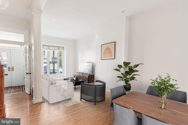 living room featuring crown molding and light wood-type flooring