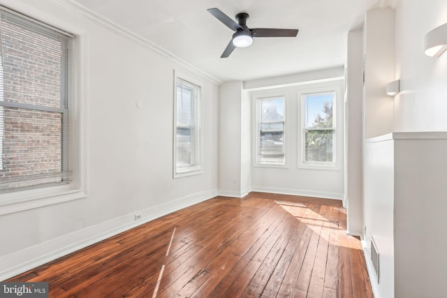 spare room featuring ornamental molding, wood-type flooring, and ceiling fan