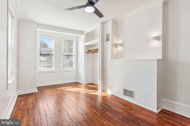 spare room with dark wood-type flooring and ceiling fan