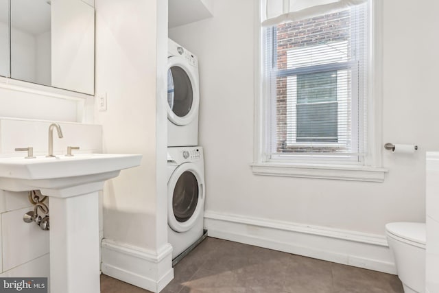 washroom with stacked washer / dryer