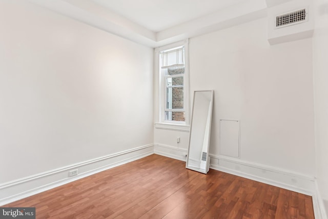 unfurnished room with wood-type flooring