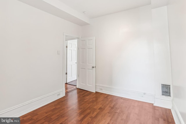 spare room featuring dark hardwood / wood-style floors