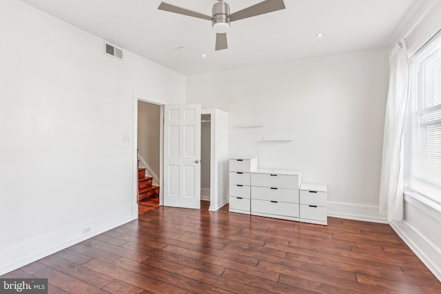 unfurnished bedroom featuring ceiling fan and dark hardwood / wood-style floors