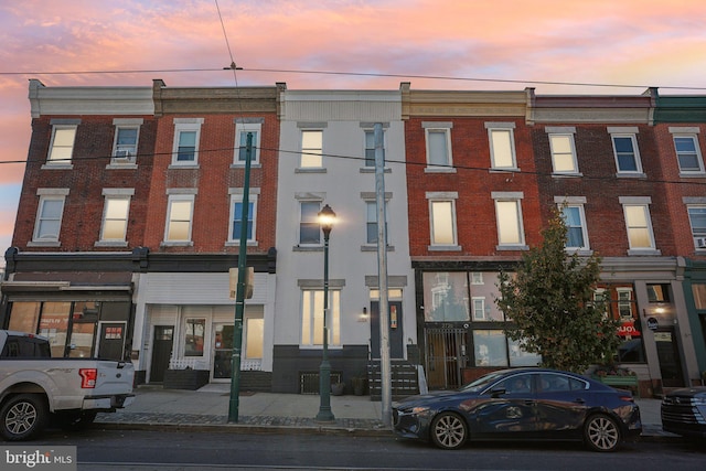 view of outdoor building at dusk