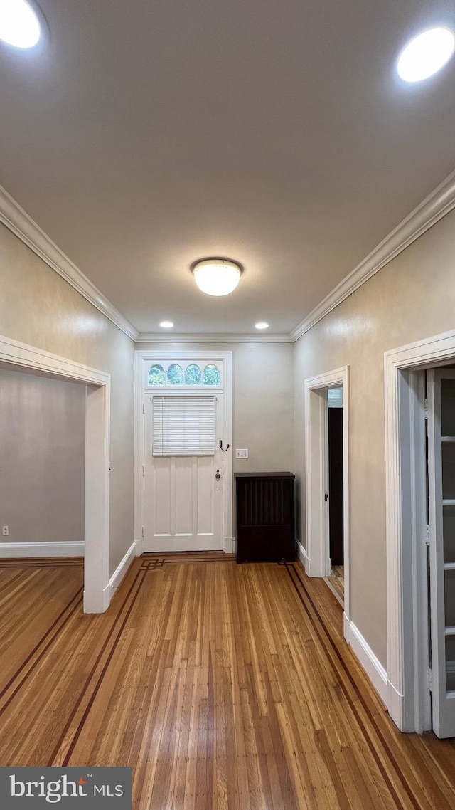 entrance foyer featuring crown molding and wood-type flooring