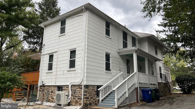 view of side of home featuring ac unit