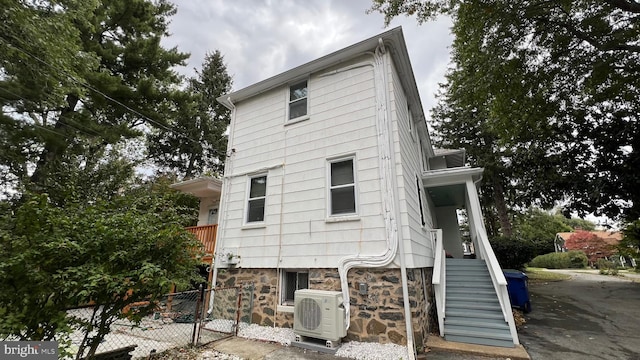 back of house with ac unit