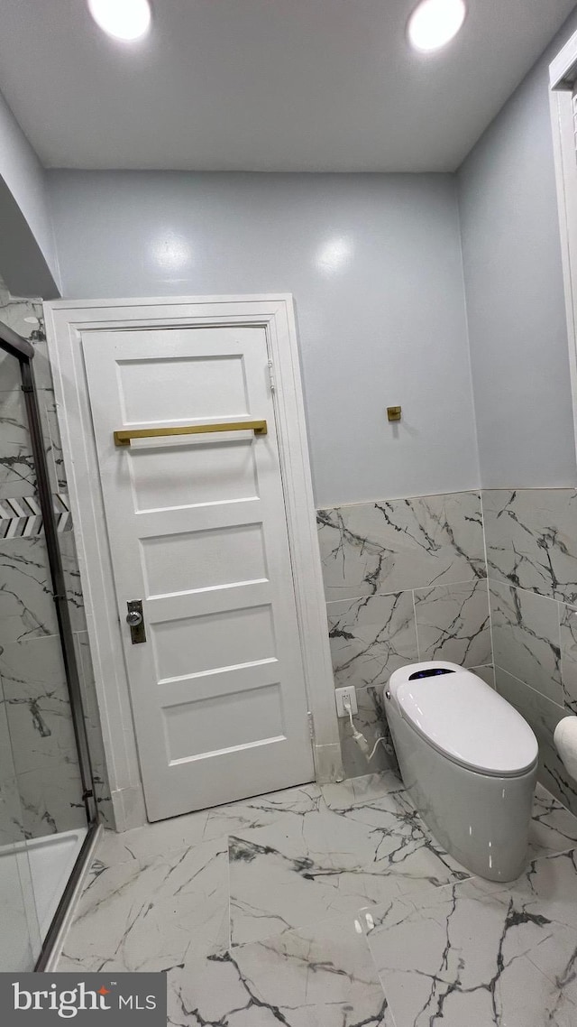 bathroom featuring toilet, walk in shower, and tile walls