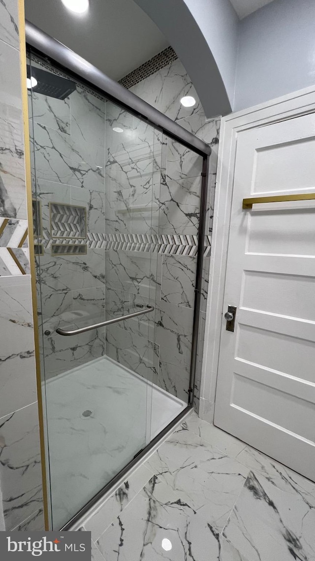 bathroom with a shower with shower door