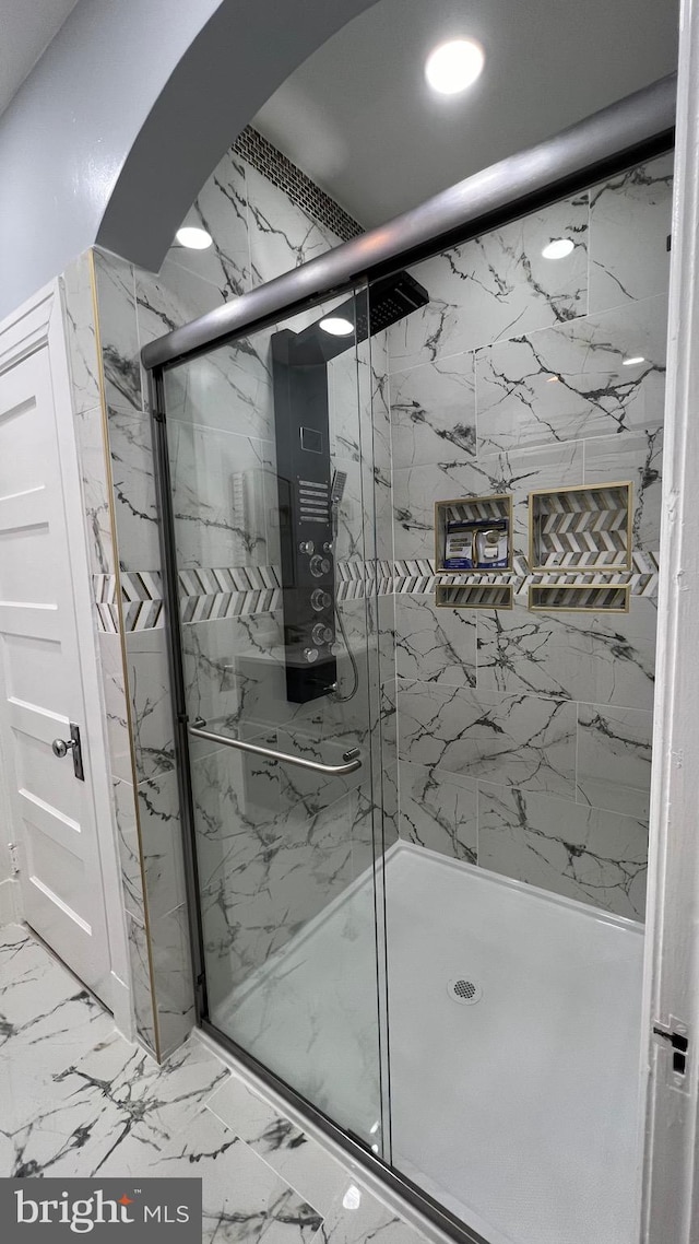 bathroom featuring a shower with shower door