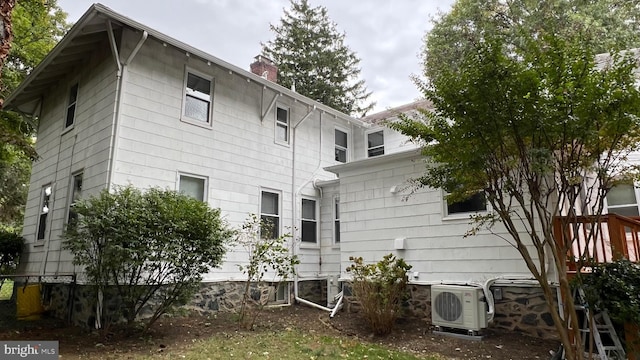 view of side of property with ac unit and central air condition unit