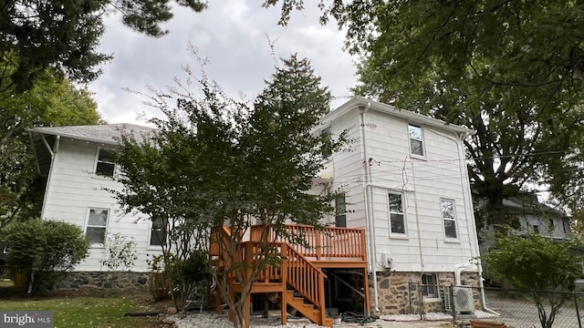 rear view of house featuring a wooden deck