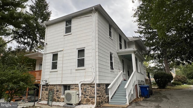 view of side of home featuring ac unit