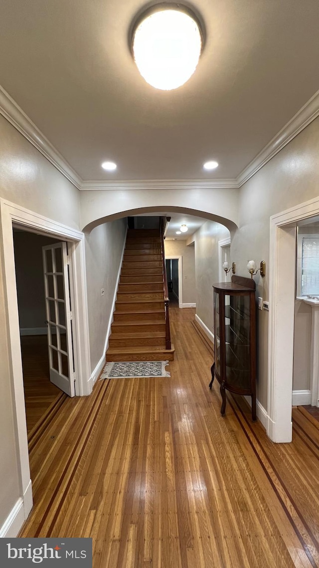 interior space with crown molding and wood-type flooring