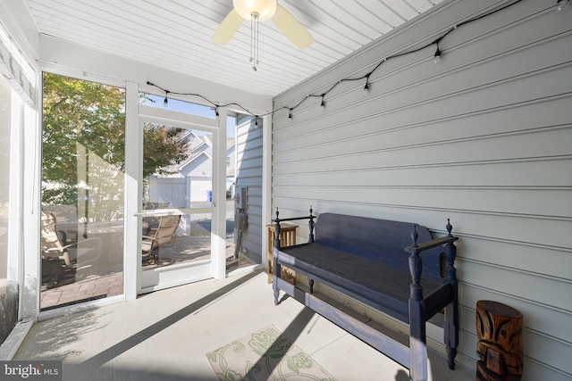 sunroom / solarium featuring a wealth of natural light, wooden ceiling, and ceiling fan