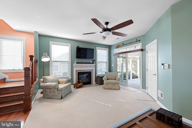 living room with carpet floors and ceiling fan