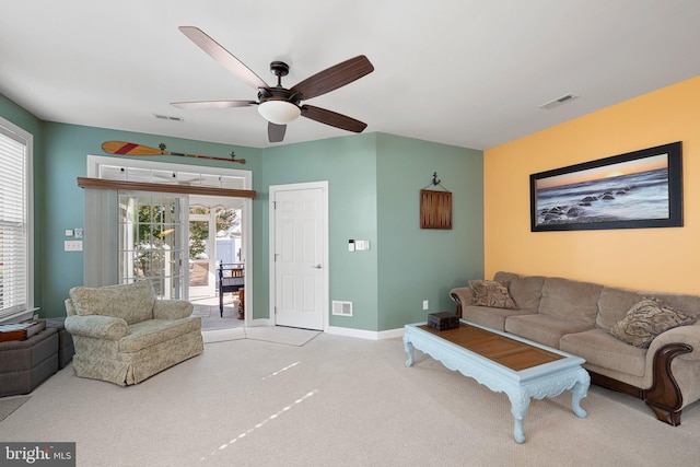 carpeted living room featuring ceiling fan