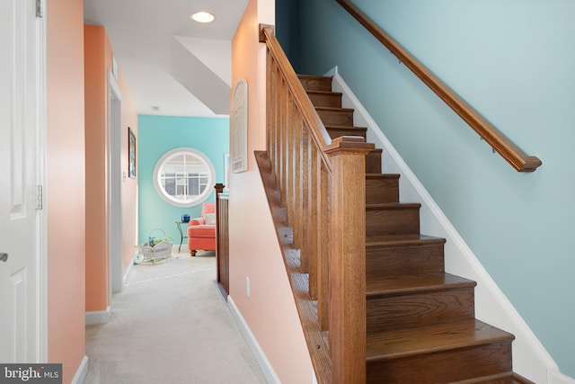 stairs featuring carpet floors