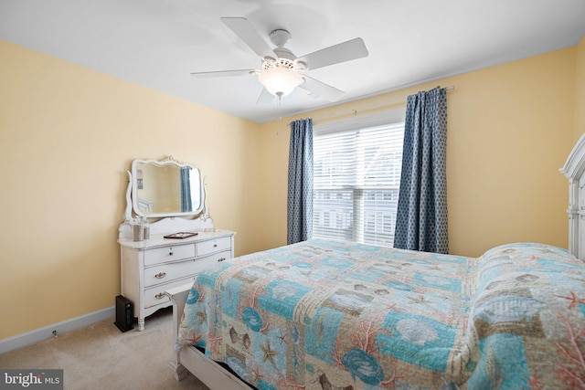 bedroom with ceiling fan and light colored carpet