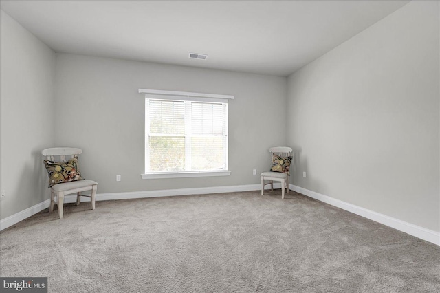 unfurnished room featuring light carpet