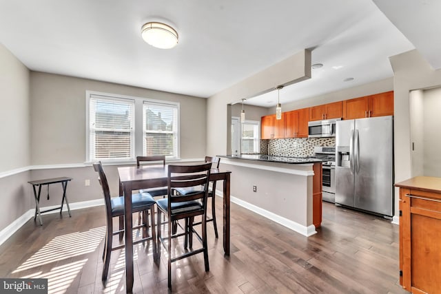 dining area featuring dark hardwood / wood-style flooring