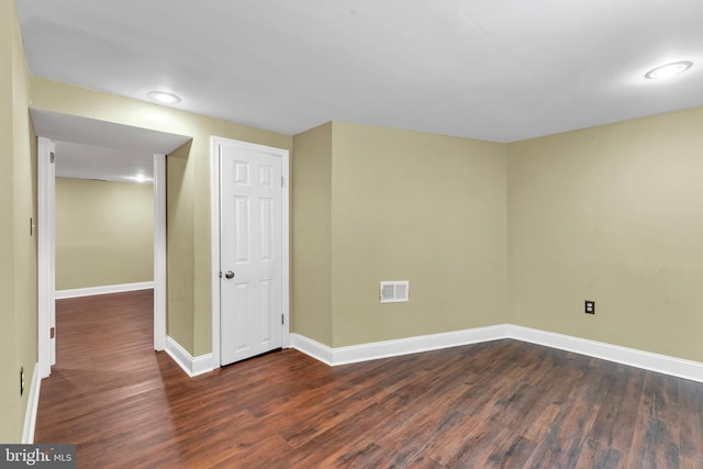 spare room featuring dark hardwood / wood-style flooring