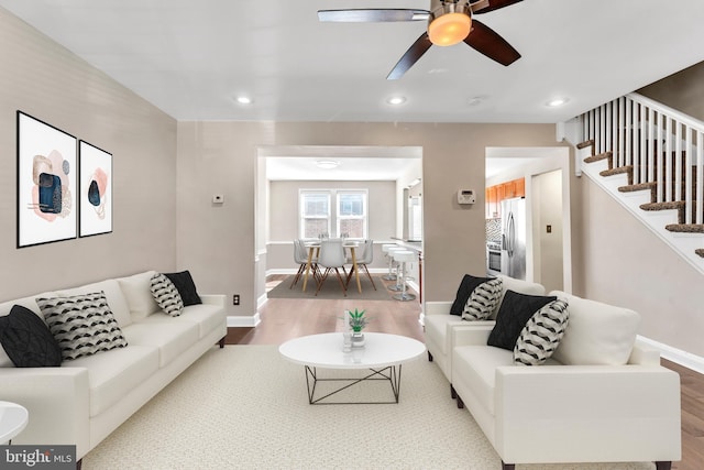 living room with ceiling fan and hardwood / wood-style floors