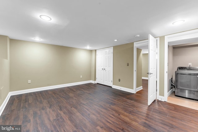 basement featuring dark hardwood / wood-style floors and washer / clothes dryer