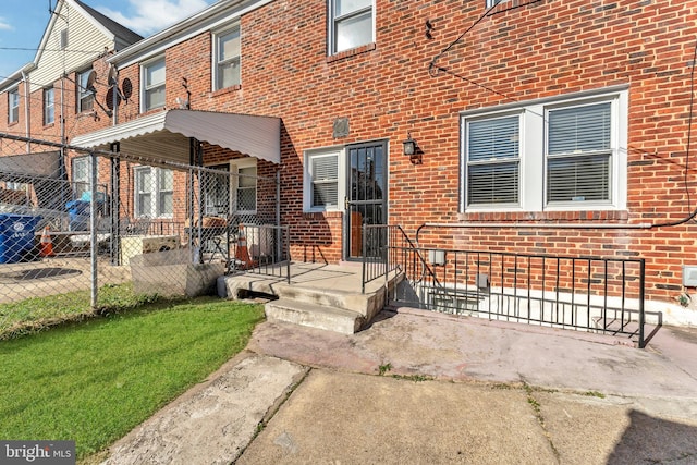 doorway to property with a lawn