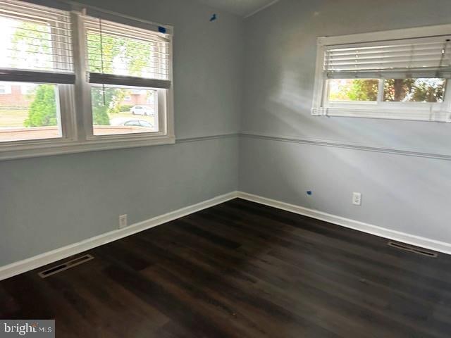 empty room featuring wood-type flooring