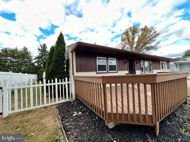 view of side of home with a deck