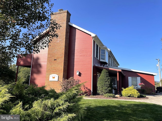 view of side of property with a yard