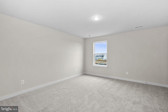 empty room featuring light carpet