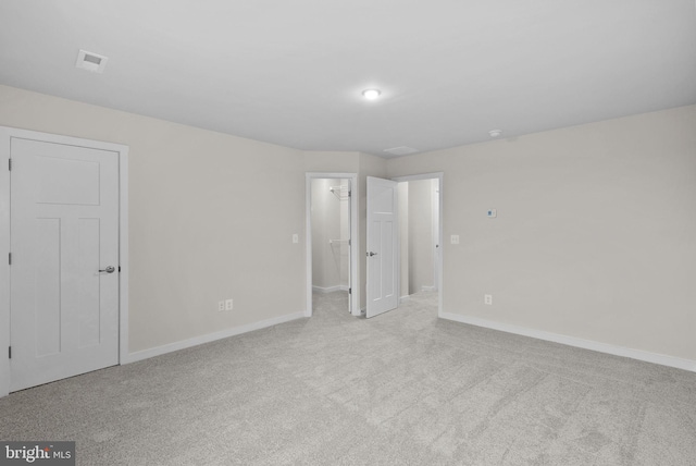 unfurnished room with light carpet