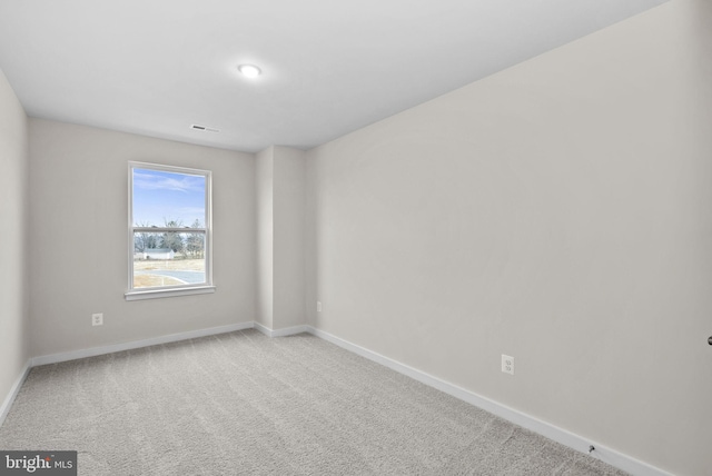 unfurnished room featuring light colored carpet