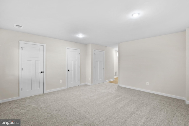 unfurnished room featuring light colored carpet