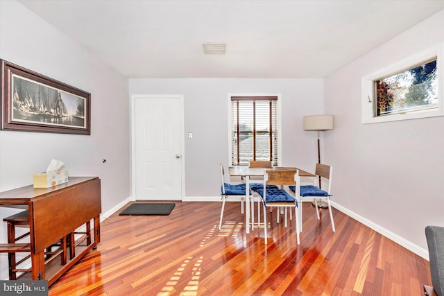 dining space with hardwood / wood-style flooring