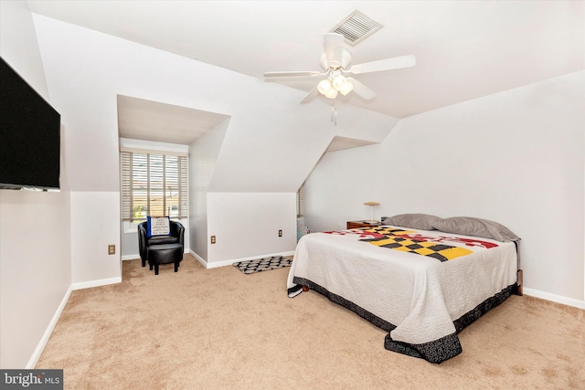 bedroom featuring vaulted ceiling, light carpet, and ceiling fan