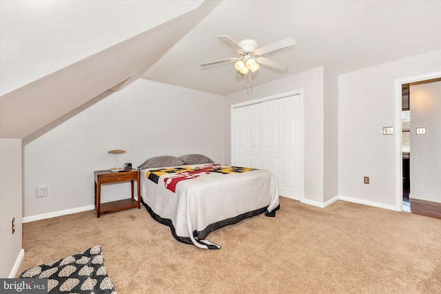 bedroom featuring light carpet, a closet, lofted ceiling, and ceiling fan