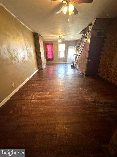 unfurnished room with dark hardwood / wood-style floors and ceiling fan