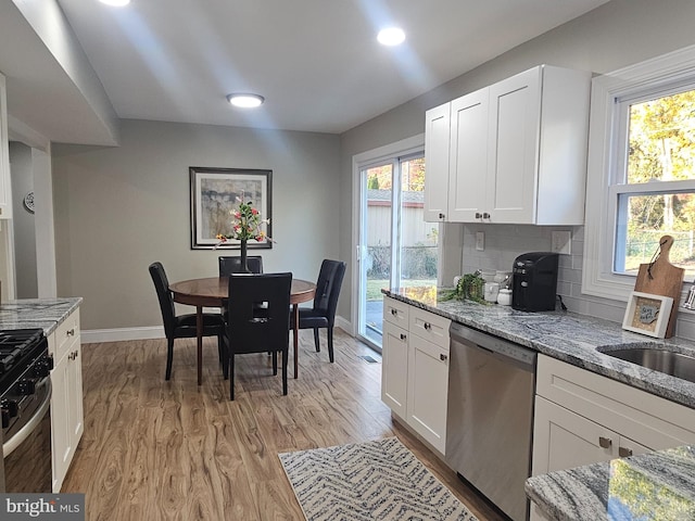 73 Genesee Ln, Willingboro, NJ 08046 - kitchen featuring light stone countertops, light wood-type flooring, baseboards, white cabinets, and appliances with stainless steel finishes