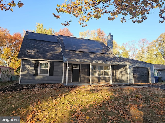 back of property featuring a garage