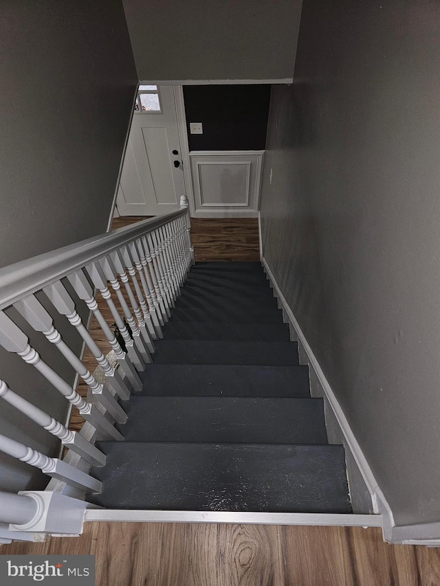 stairs with wood-type flooring