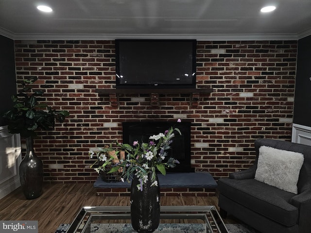 73 Genesee Ln, Willingboro, NJ 08046 - living room featuring crown molding, recessed lighting, wood finished floors, and brick wall