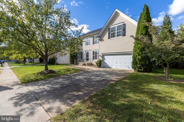 view of front of property featuring a front yard and a garage